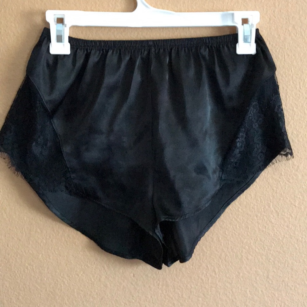 Black satin shorts with lace cutouts